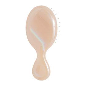 Wet Brush mini detangler front packaging showing cream iridescence and compact size benefit