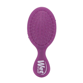 Wet Brush mini detangler front view showing compact shape and travel convenience