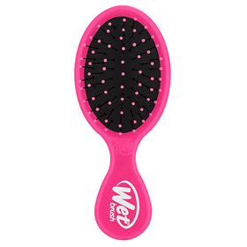 Wet Brush mini detangler front view showing compact pink design and portability