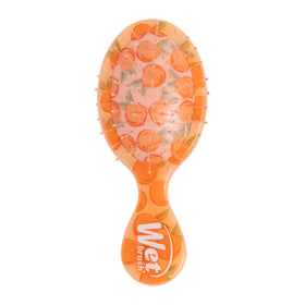 Wet Brush Mini Detangler front view showing compact peach design and easy grip