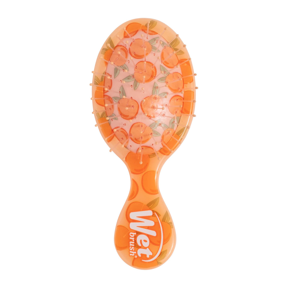 Wet Brush Mini Detangler front view showing compact peach design and easy grip