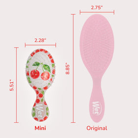 Wet Brush Mini Detangler held in hand to show scale and ease of grip for travel use