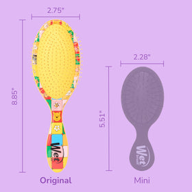Wet Brush held in hand to show compact scale and portable convenience for travel