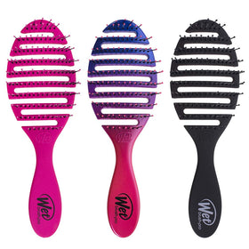 Wet Brush held in hand for scale showing compact size and easy travel benefit