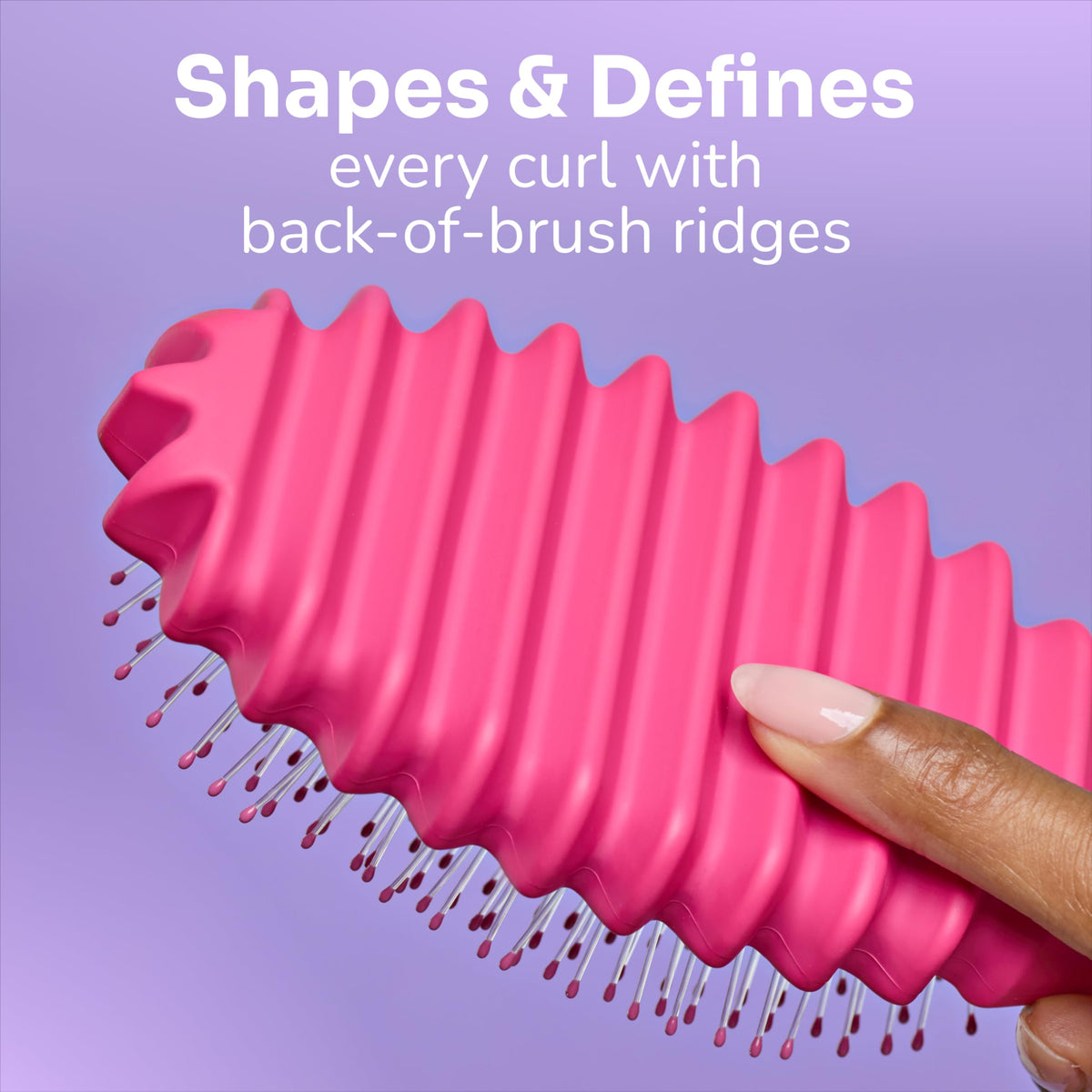 Wet Brush held in hand to show compact size and portability for travel