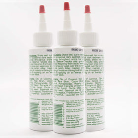 Wild Growth applying a few drops with fingertips to hair for easy detangling benefit