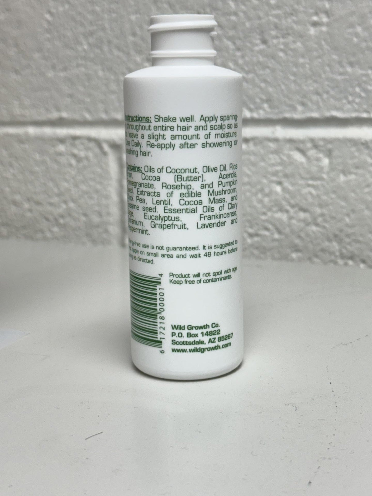 Wild Growth oil close-up texture on hand highlights lightweight conditioning