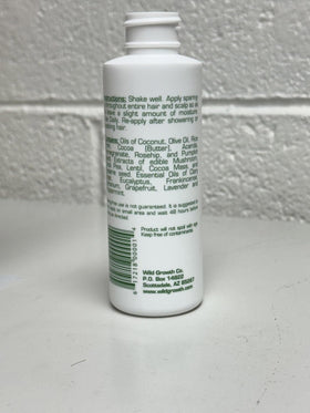 Wild Growth oil close-up texture on hand highlights lightweight conditioning