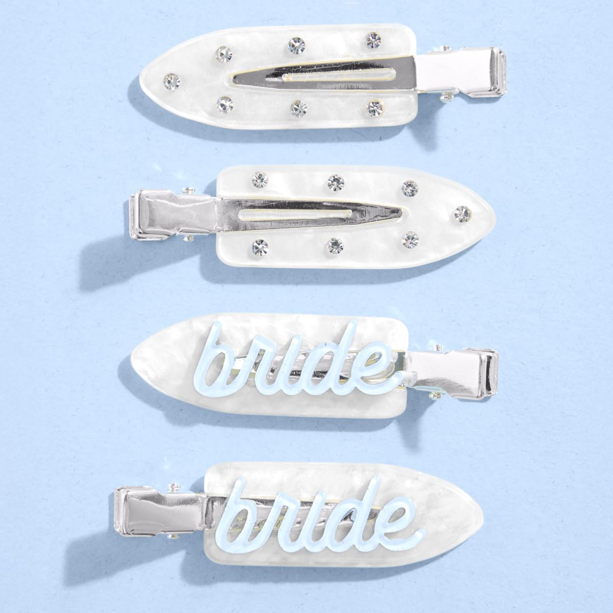 xo, Fetti front view of four white bridal hair clips showing blue script and rhinestones as pretty accessories