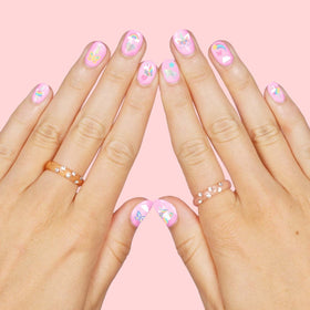 xo, Fetti decal being applied on a child’s nail for quick party manis
