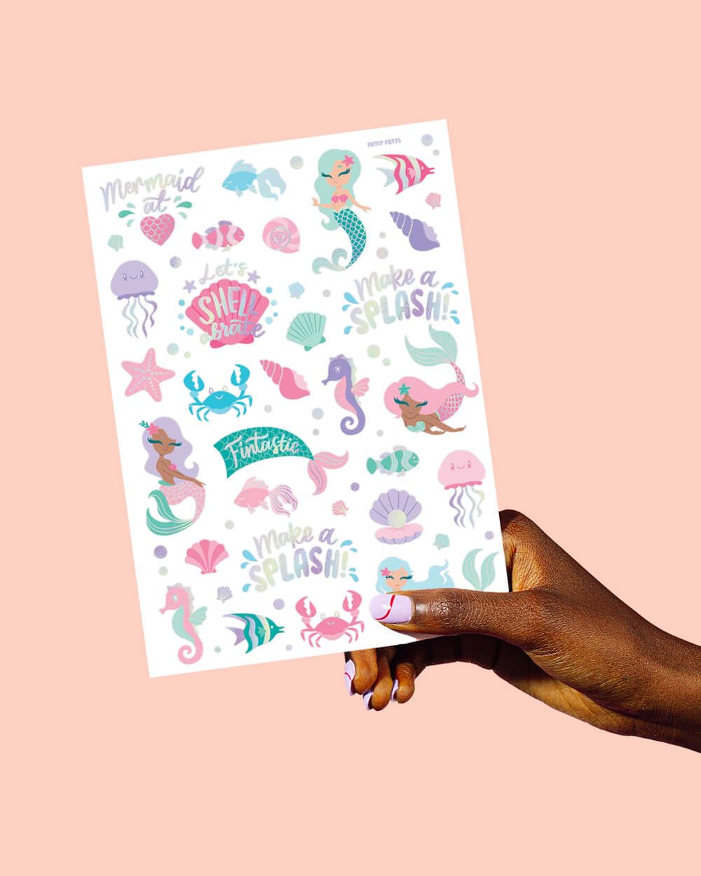 xo, Fetti child wearing multiple mermaid tattoos smiling to show party fun