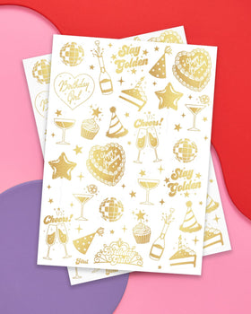 xo, Fetti close-up of gold-foil tattoos displaying detailed designs and sparkle