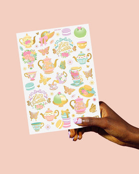 xo, Fetti hand holding one sheet to show scale and party-ready quantity