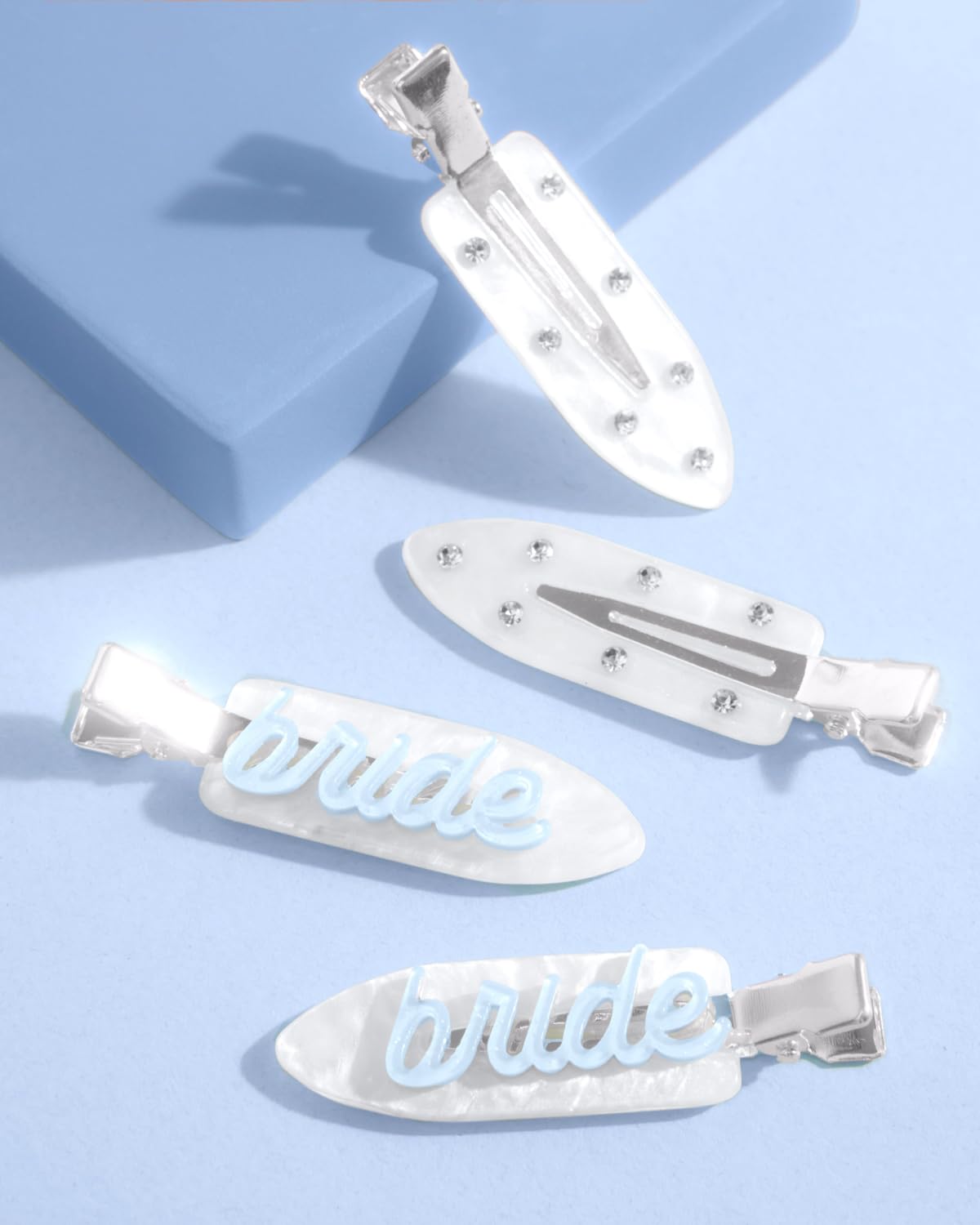 xo, Fetti clips beside a coin for scale illustrating compact size for travel and purses
