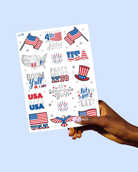 xo, Fetti tattoo sheet next to a hand to show scale and usable sizes