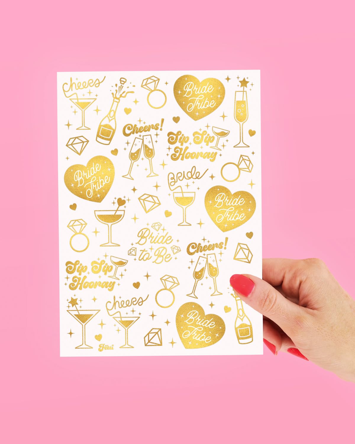 xo, Fetti sheet held by hand illustrating tattoo size and scale for guests