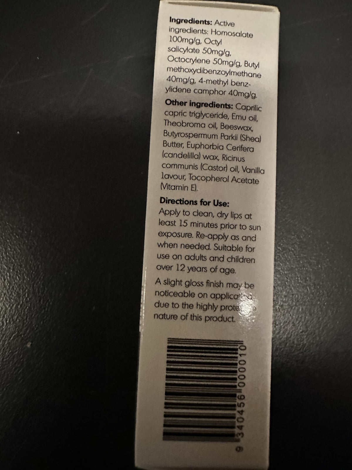 Y Not Natural lip balm on a beach towel illustrating outdoor sun protection use