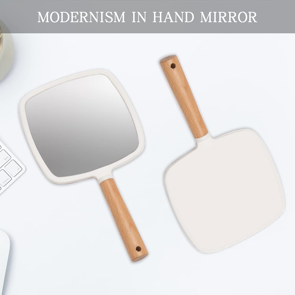 YEAKE hand mirror held in hand to show true scale and travel-friendly size
