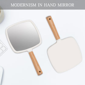 YEAKE hand mirror held in hand to show true scale and travel-friendly size