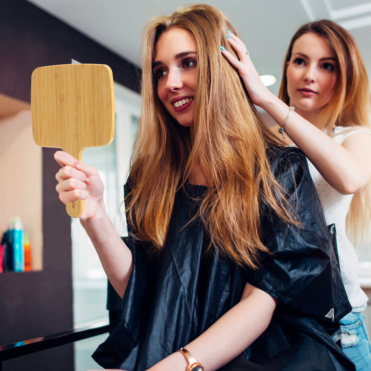 YEAKE hand holding mirror showing scale and comfortable grip benefit