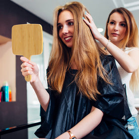 YEAKE hand holding mirror showing scale and comfortable grip benefit