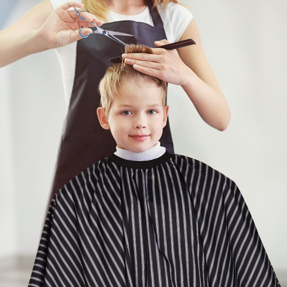 YELEGAI cape in use on a salon chair for tidy, professional haircuts