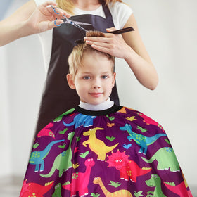 YELEGAI cape draped on chair showing full 39x55 coverage, protects clothing fully