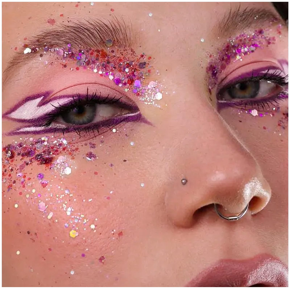 YGQQOY glittered festival attendee under lights demonstrating dramatic concert glow