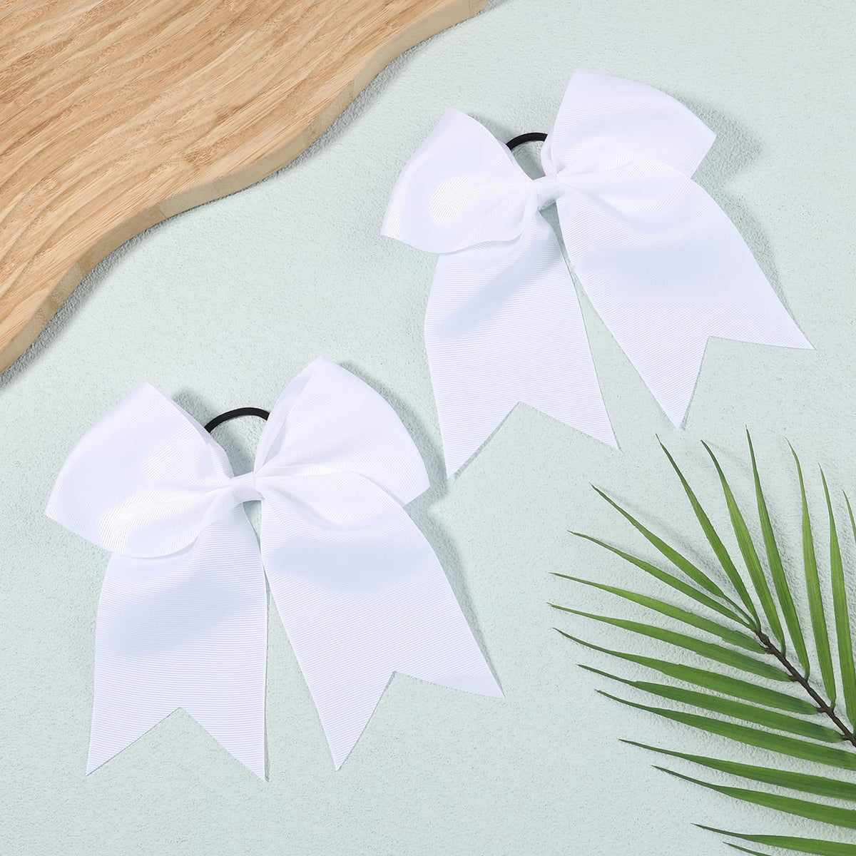 YHXX YLEN bows paired with a cheer uniform illustrating coordinated team appearance