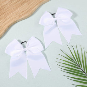 YHXX YLEN bows paired with a cheer uniform illustrating coordinated team appearance