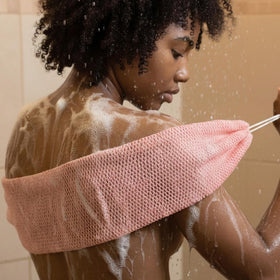 Yiclick in a shower setting with towel showing everyday bath routine utility