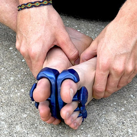 YogaToes Gems men's size comparison next to coin showing compact portable benefit