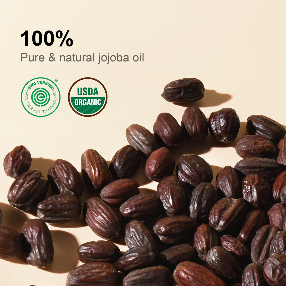 Golden jojoba oil being poured, shows smooth texture and absorbency