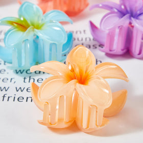 YosaiHom clips styled in a bun on model illustrating secure hold and tropical look