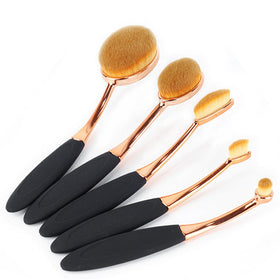 Yoseng applying liquid foundation with oval brush for smooth finish