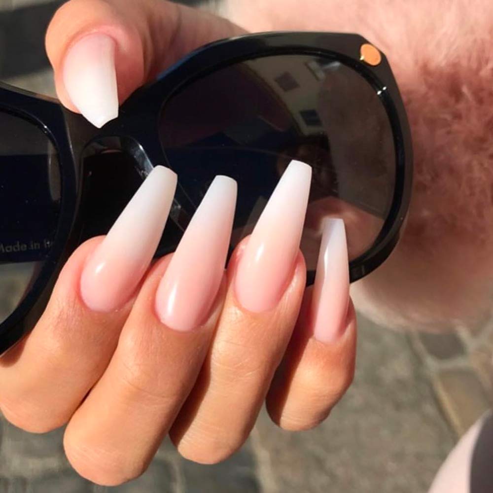 Young Nails top coat in lifestyle setup with tools highlighting salon-grade protection and shine