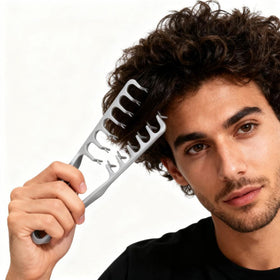 YRAKOZIN comb held in hand to show portable size and comfortable non-slip grip
