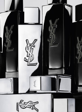 Yves Saint Laurent bottle next to hand for size comparison and practical portability