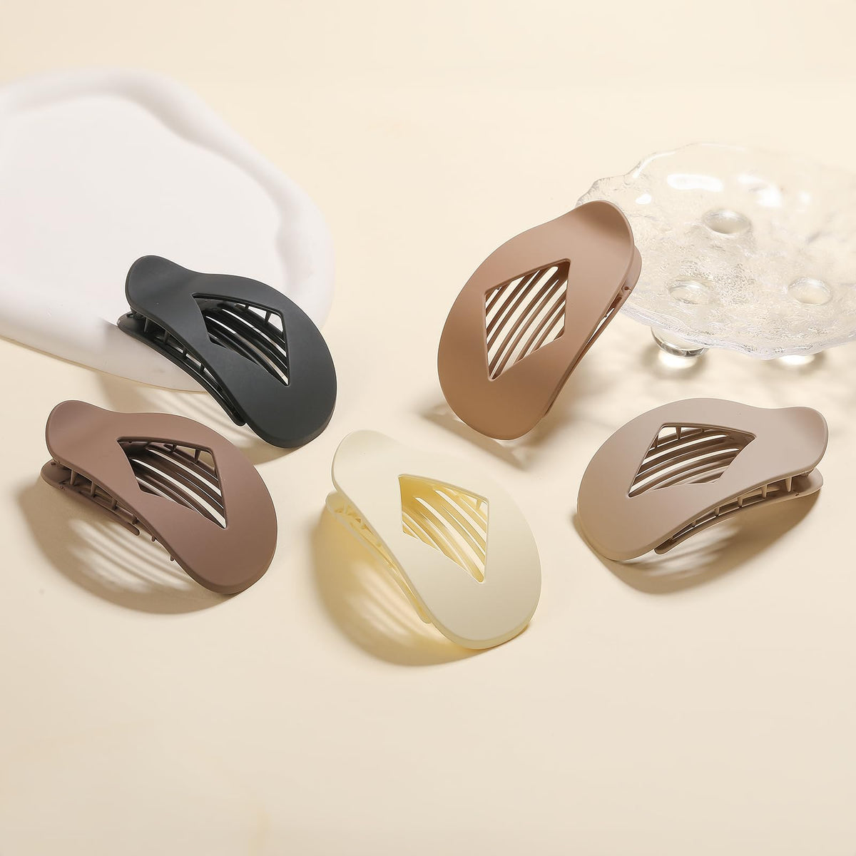 Yswulj clips styled on a countertop in neutral room setting, shows everyday styling versatility