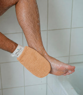 Zakia's Morocco mitt in shower lifestyle image showing practical use during bathing routines