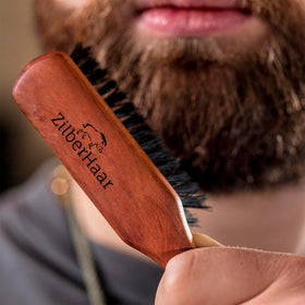 ZilberHaar brush in use spreading beard oil evenly for polished look