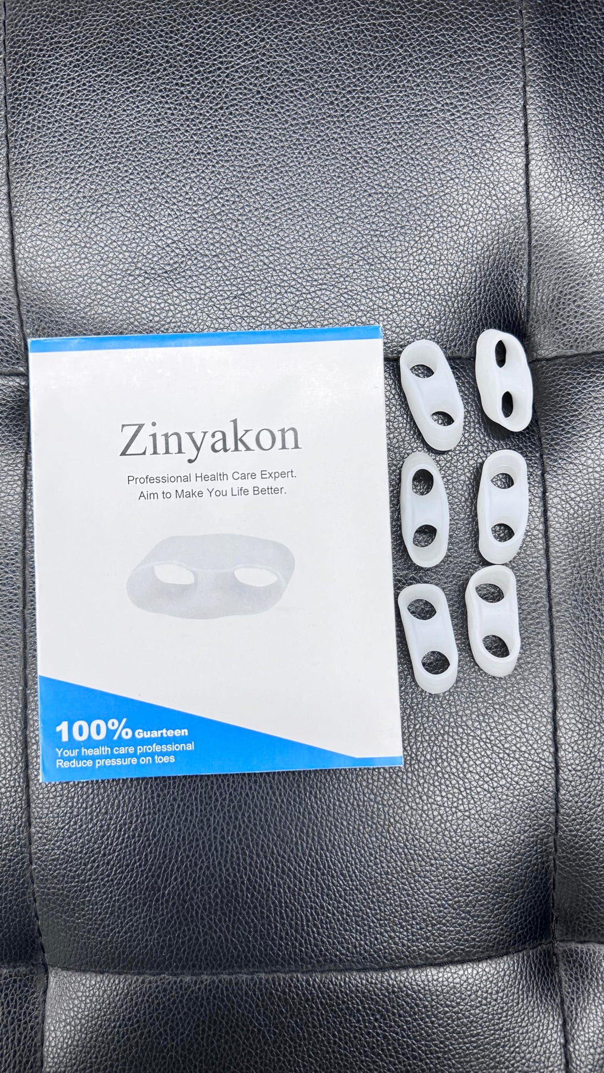 Zinyakon toe separator worn while resting in bed, showing comfortable overnight use