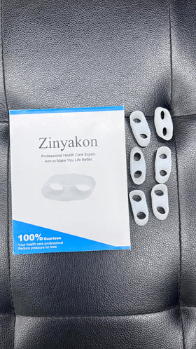 Zinyakon toe separator worn while resting in bed, showing comfortable overnight use