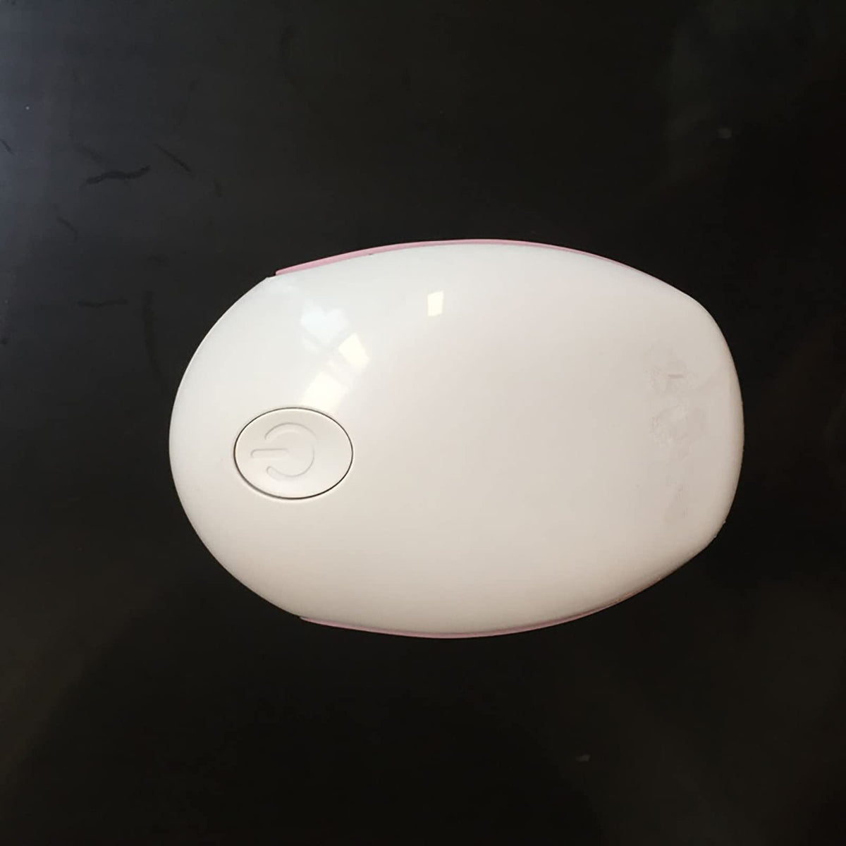 Zjyufy next to smartphone for scale showing travel-friendly compactness benefit